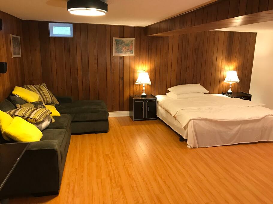 King bed with sofa set in the walk-out bsmt