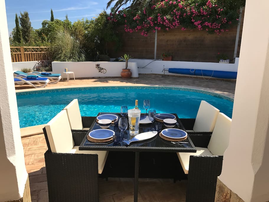 One of three patio tables overlooking pool