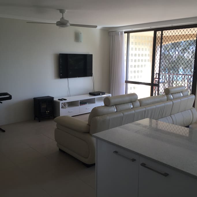 LCD TV with Foxtel, beautiful leather couch and ceiling fan