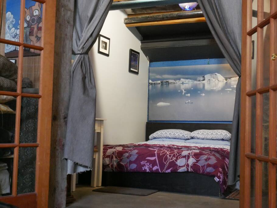 Queen bed in Suite bedroom. Double doors can be latched and curtains can be put down for privacy.