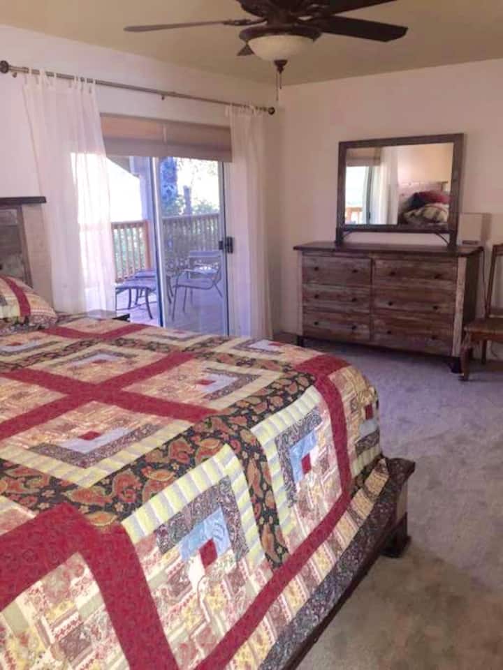 Master king bedroom with sliding door to covered deck