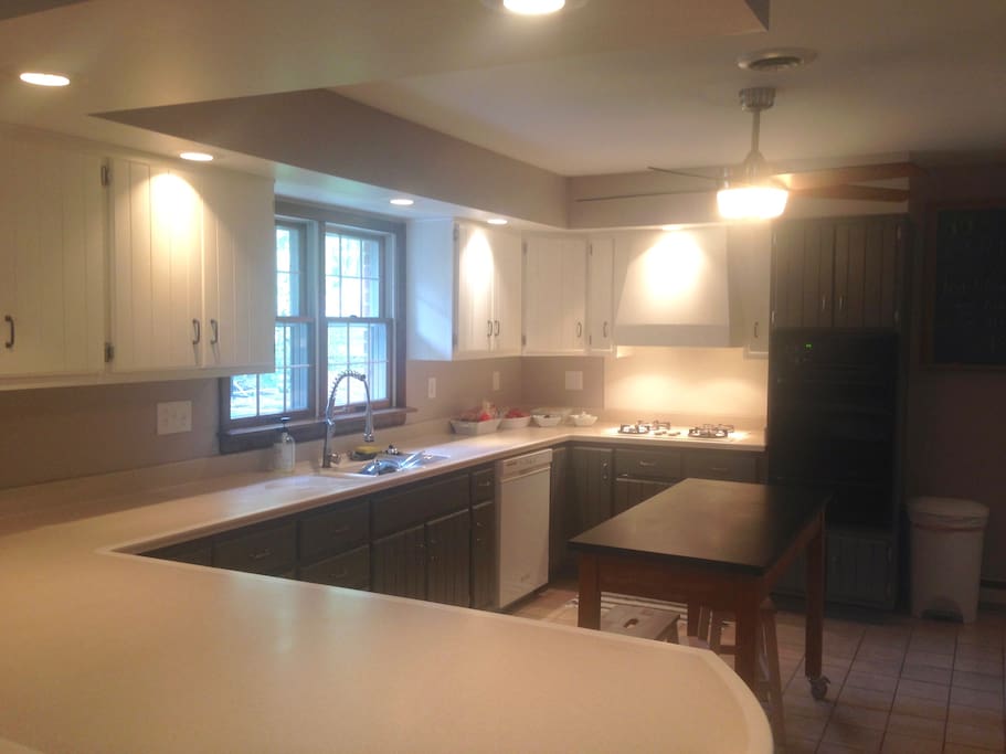 Spacious kitchen with gas stove and oven.