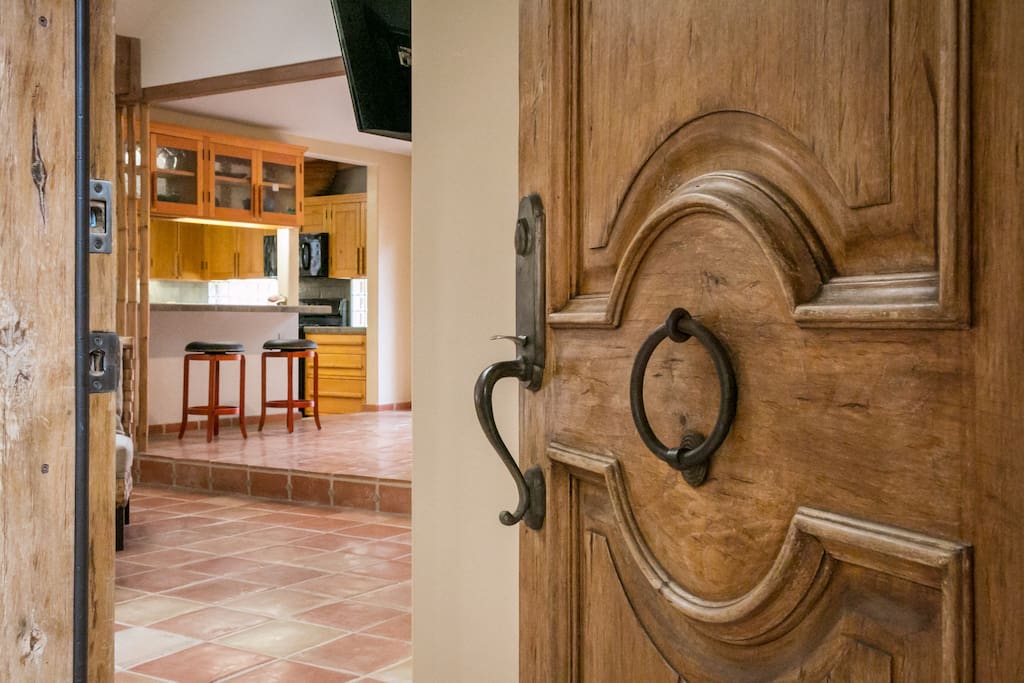 An antique door and rock walls mark the front entrance.