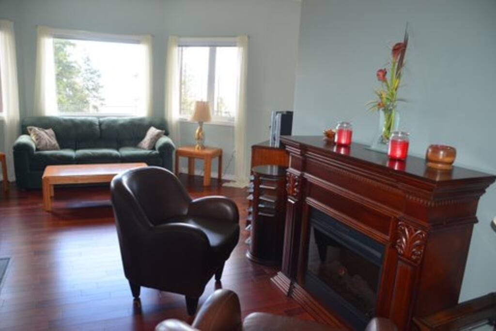 Living room with cosy club chairs around fireplace