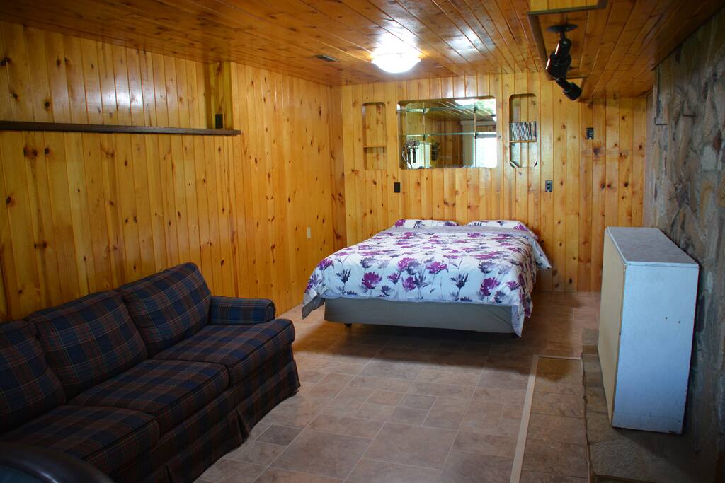 Large Bedroom. Queen size memory foam bed, high quality memory foam pillows, and a queen size Hide-a-bed in the couch.