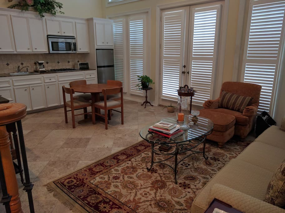 1st floor common space with kitchen, sofa, dining table, microwave and refrigerator.