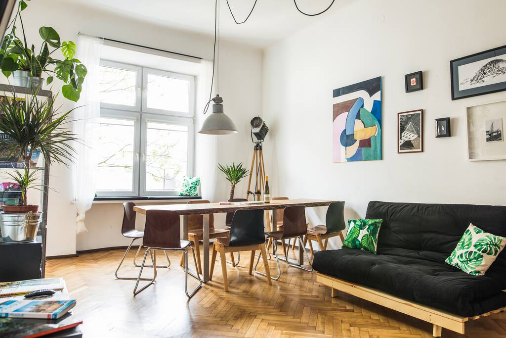 Living room with a sofa bed and a large oak table for 8 people