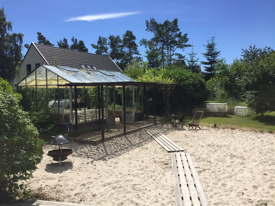 "Beach" in the garden with a greenhouse built for late night dinners