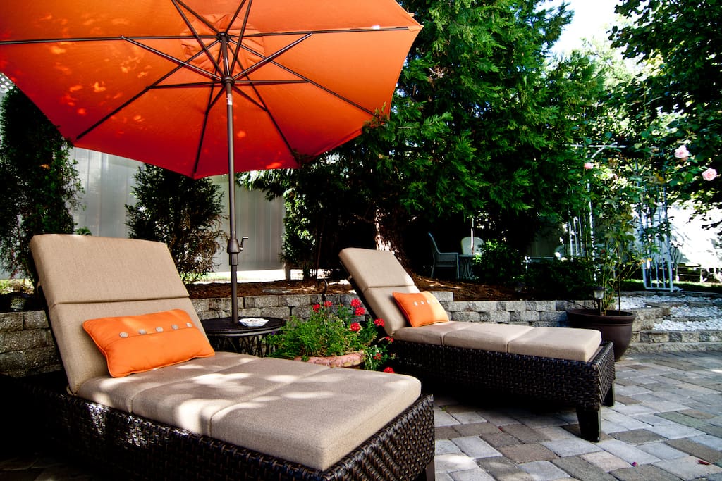 The perfect getaway... chaise lounges, patio seating, a firepit, and a secret garden!