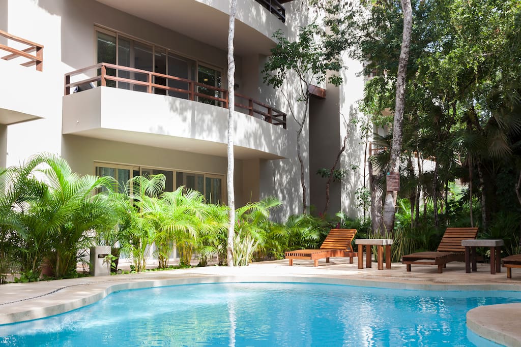 View of the apartment front sliding doors thru the foliage greens