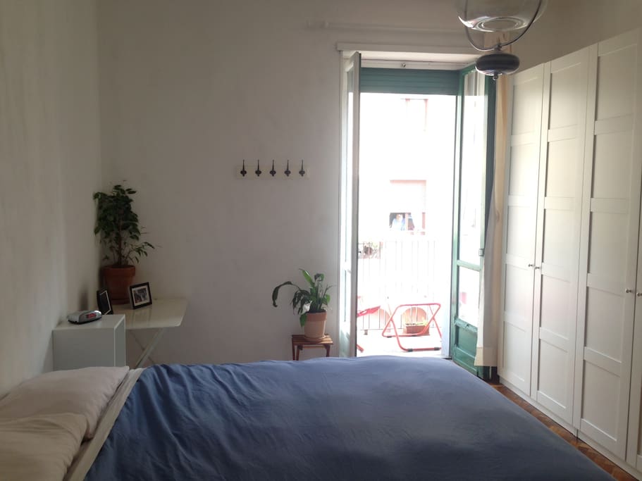Double bed in bedroom with balcony