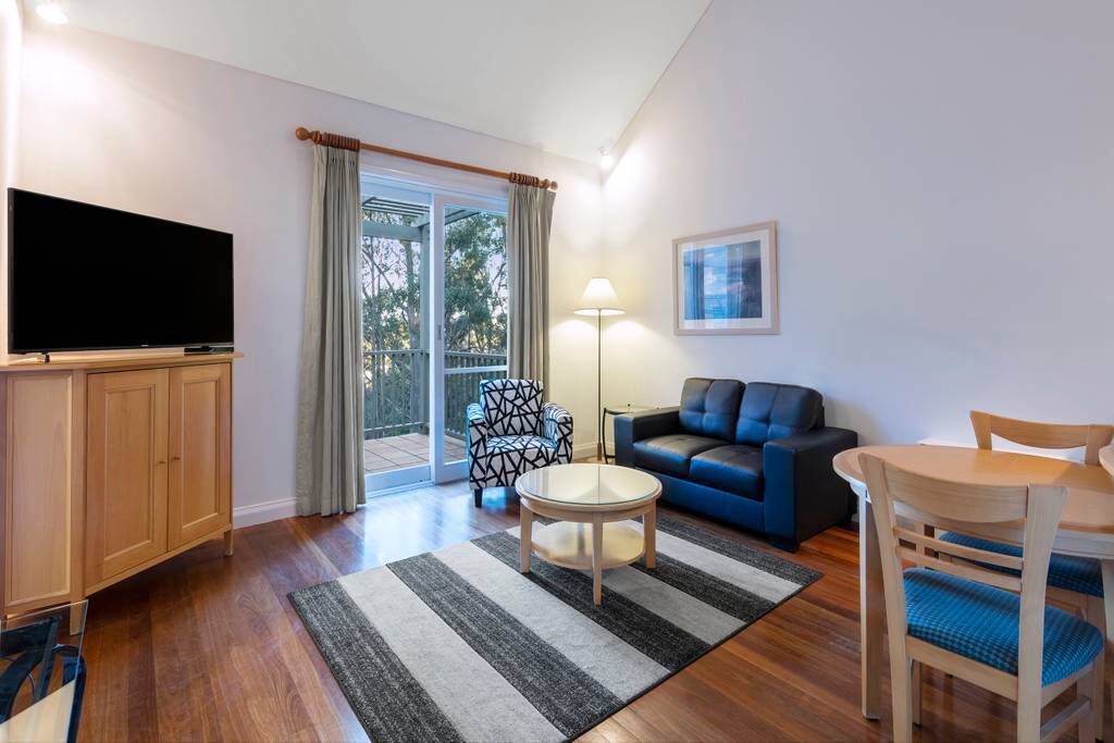 1 Bedroom Villa: Living room with access to private balcony