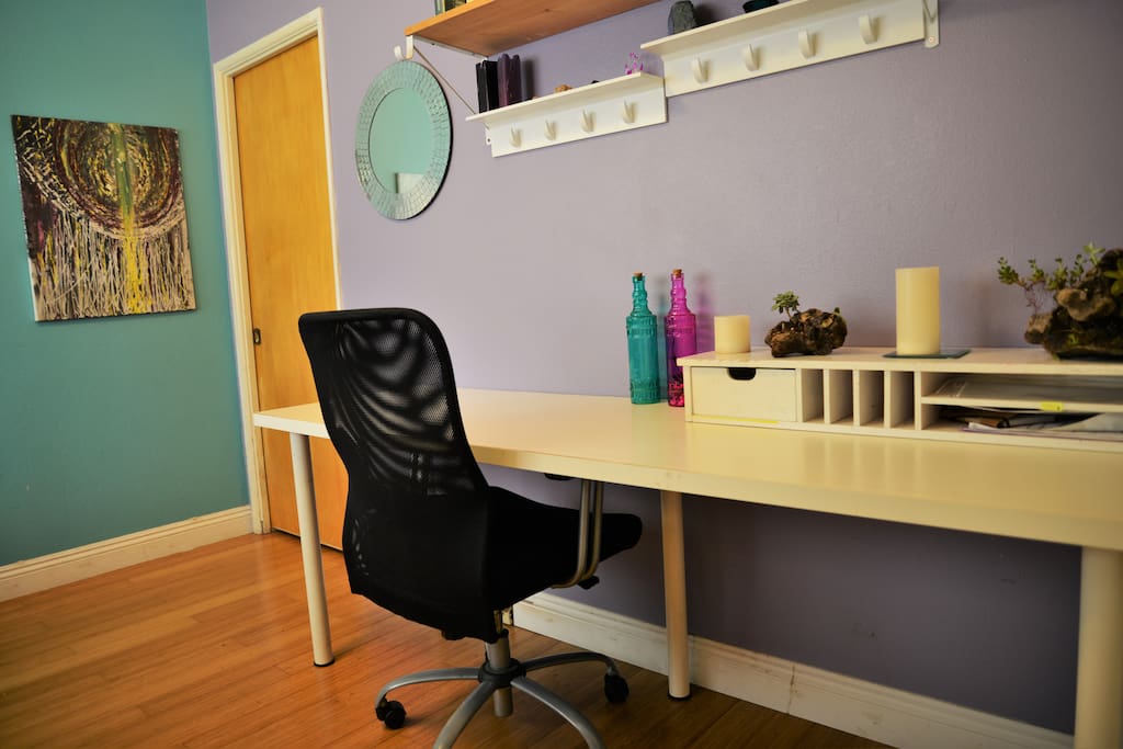 Private room has desk, chair, shelving and place to hang clothes