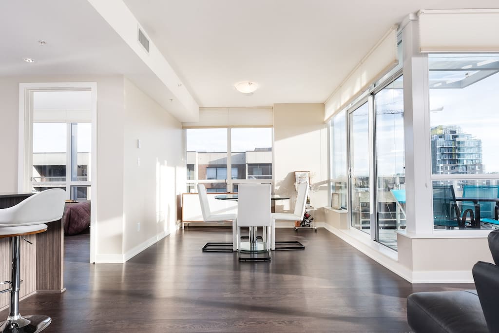 Open concept dining room with beautiful extendable glass table