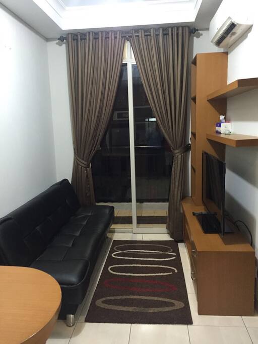 Living room with a sofa-bed and LED TV with local channels