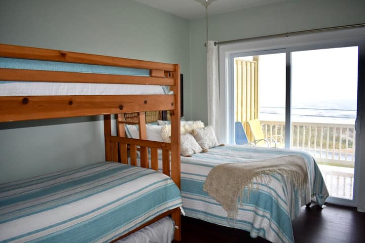The third bedroom is the party room!  Access to the ocean side balcony and another terrific view of the  ocean.  Full bed and three singles.