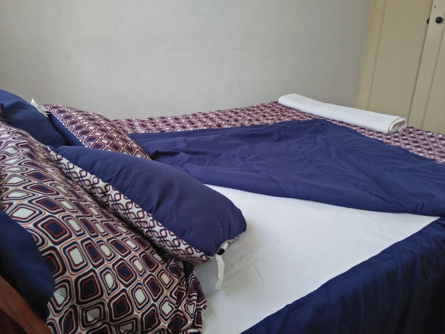 Stylish printed duve on spacious bed with extra pillows for extra comfort