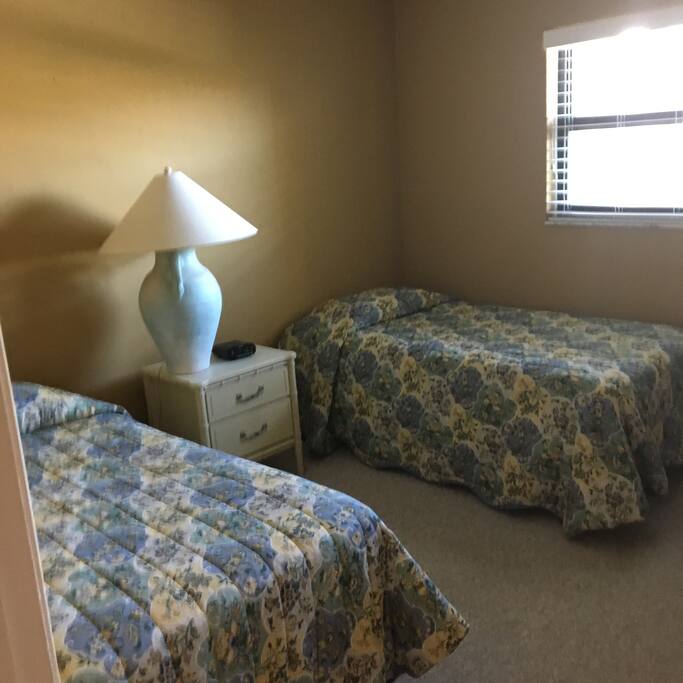 2 twin beds in guest bedroom looking in door