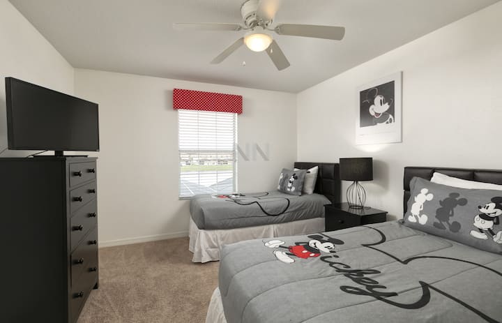 Sleep like a baby in our suite with Mickey-themed linens, two double beds, smart TV, and ceiling fan.