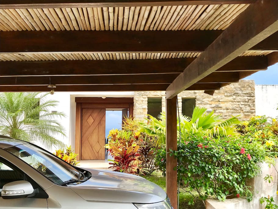 Entrance. We have a covered parking lot for two cars and an uncovered area for two or three additional cars.