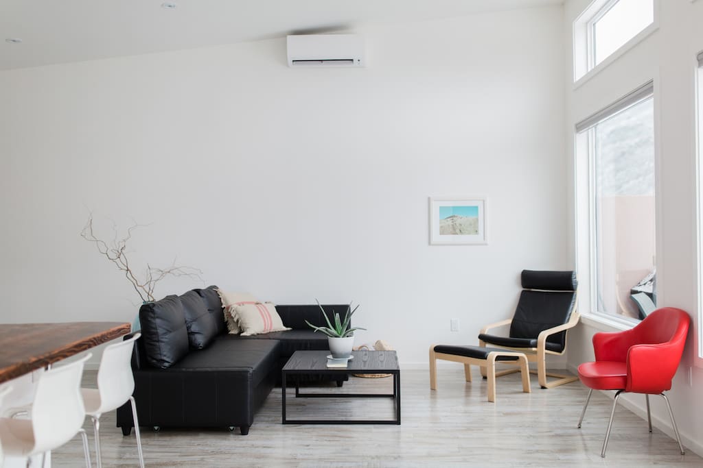 Bright and airy living space including a pull out couch with queen sized mattress