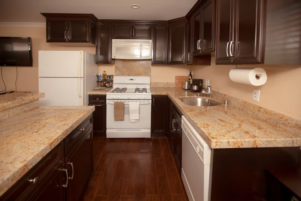The kitchen is equipped with a full-size refrigerator, microwave, gas range and oven. There is a generous and deep stainless steel sink with a garbage disposal and dishwasher.