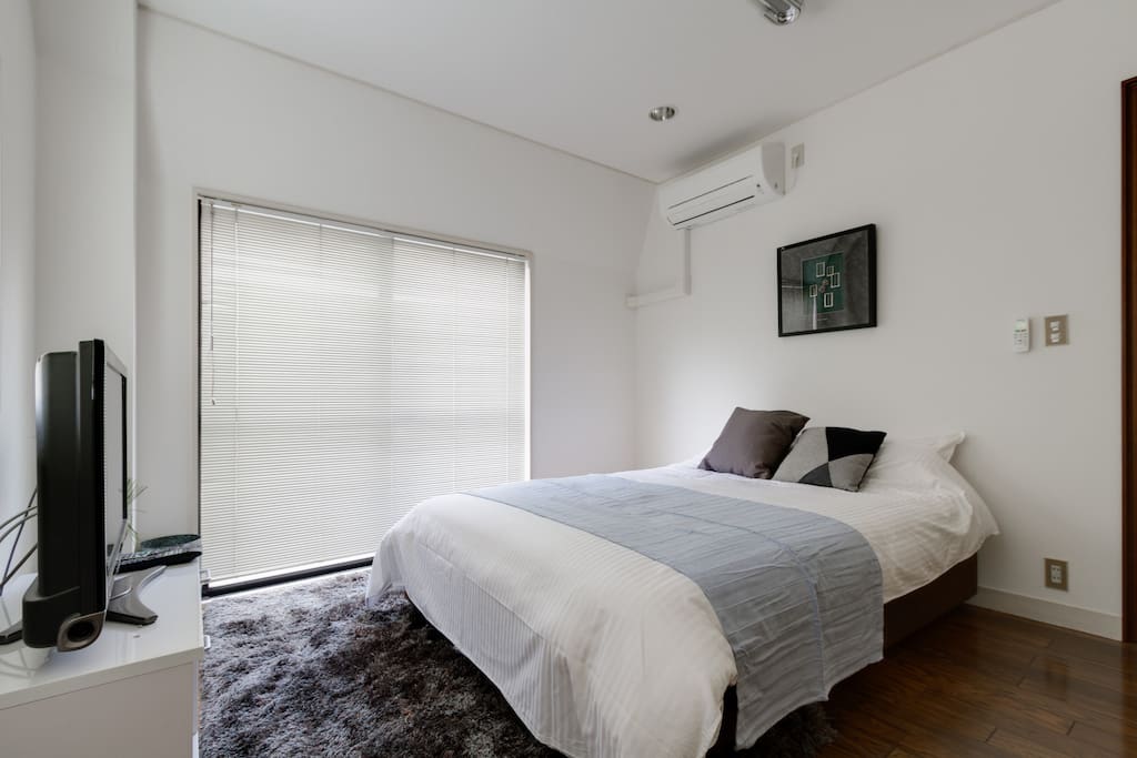 comfortable room with a tv and nice bed