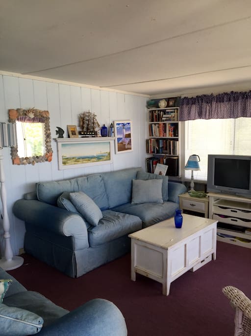 Living room with plenty of seating and sunlight.
