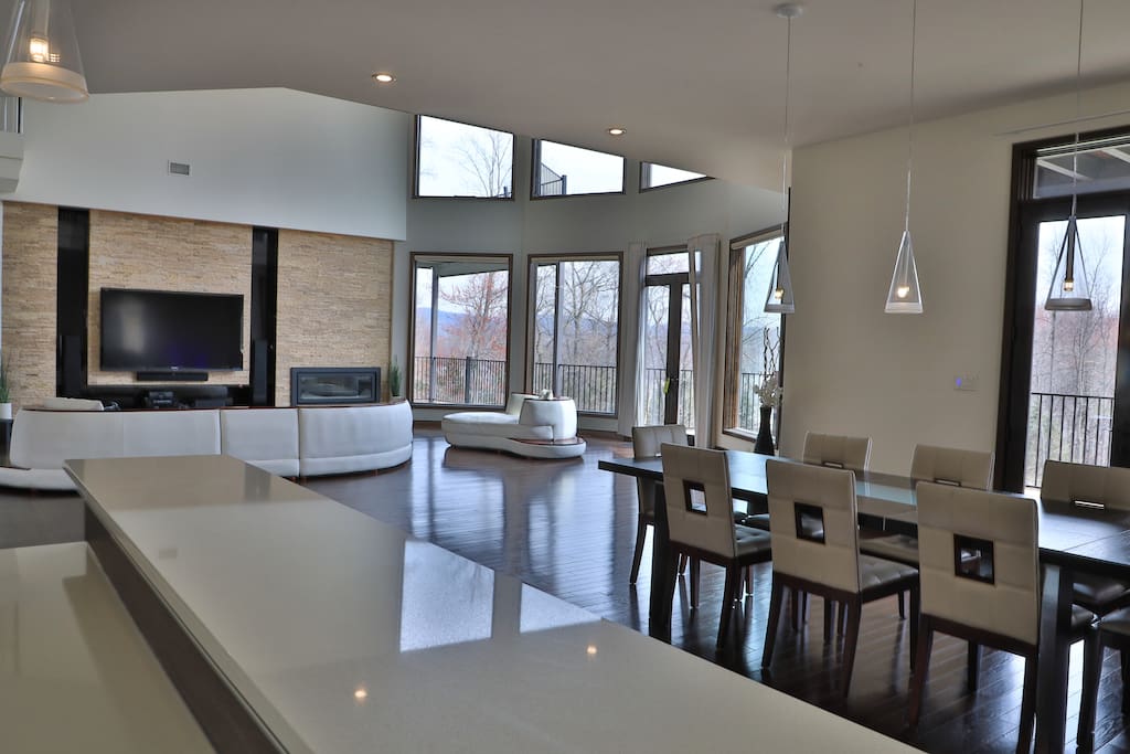 Dining table and living room view from the bar with dynamic lighting