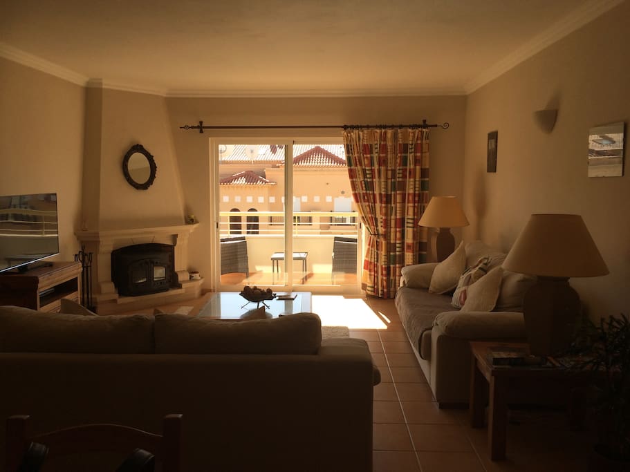 Living room with fire place and balcony