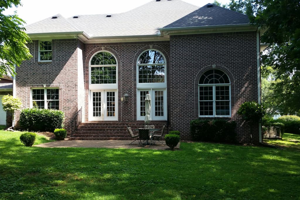 Shady backyard with large patio for entertaining