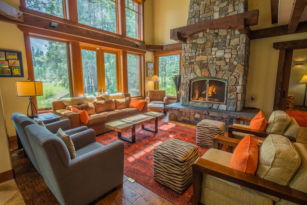 Comfortable great room furniture and a large ledgestone gas fireplace.