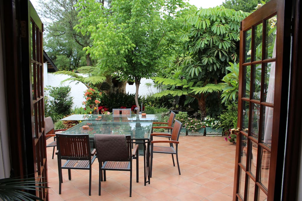 Direct access to enclosed patio with fountain and garden umbrellas
