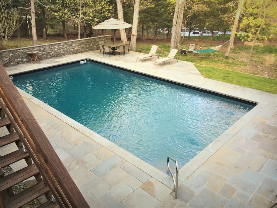 Blue stone deck surrounding heated pool