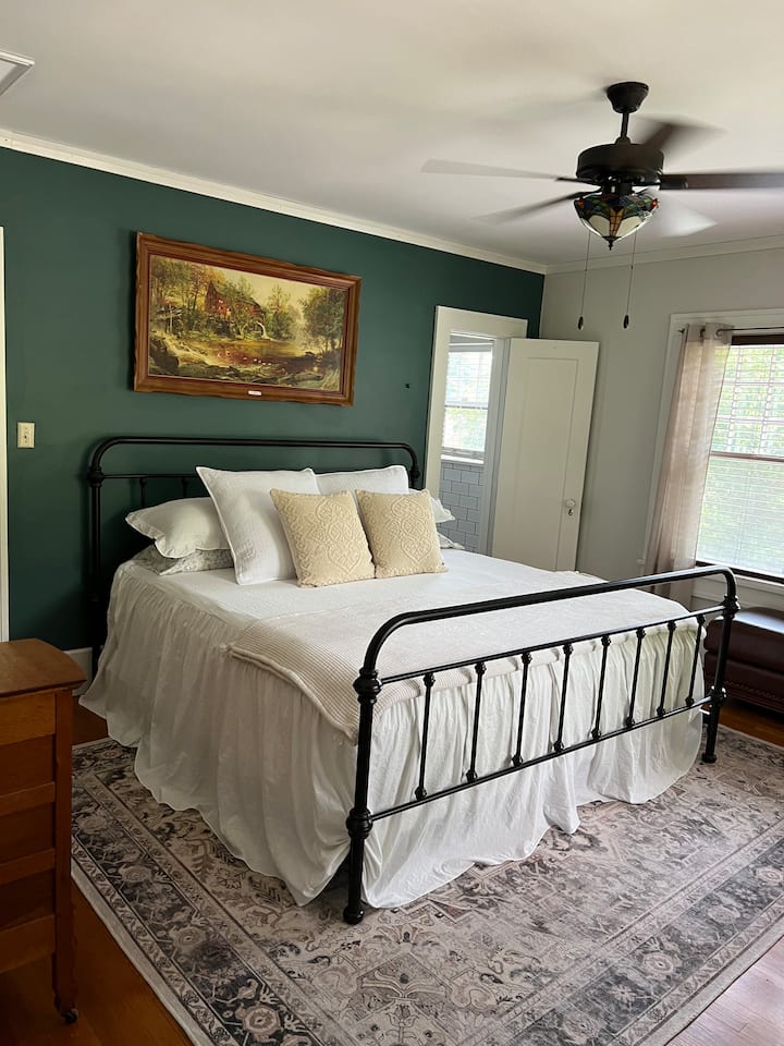 Master bedroom with king size bed. Located at the tops of the stairs on second story. Full bathroom with tub and shower off of master bedroom. 