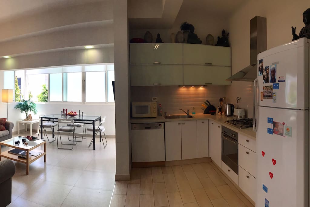 Fully equipped kitchen next to open plan sitting room.
Bright and airy