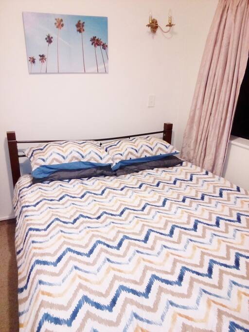 Queen bed with duck feather pillows