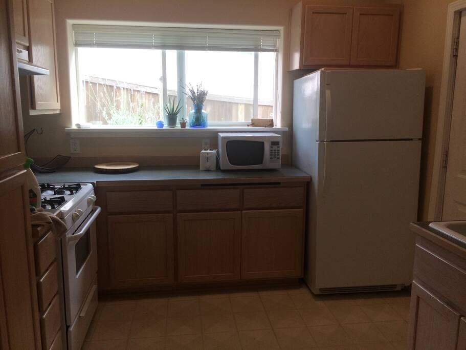 Fully stocked kitchen features gas range and dishwasher.