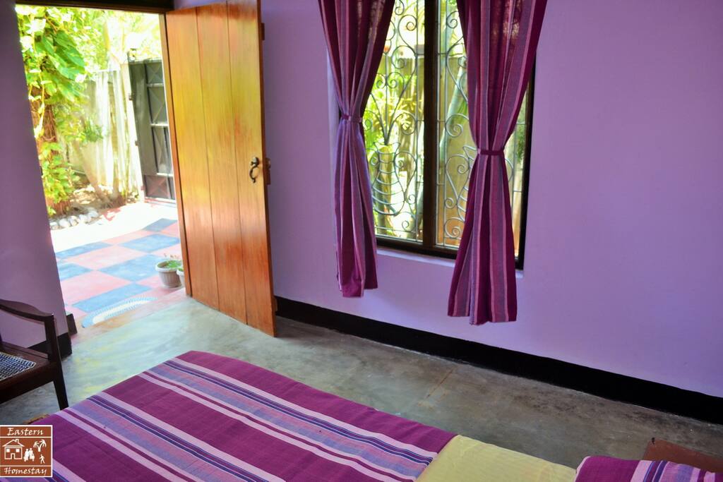 A simple room opening on a flowered yard and garden