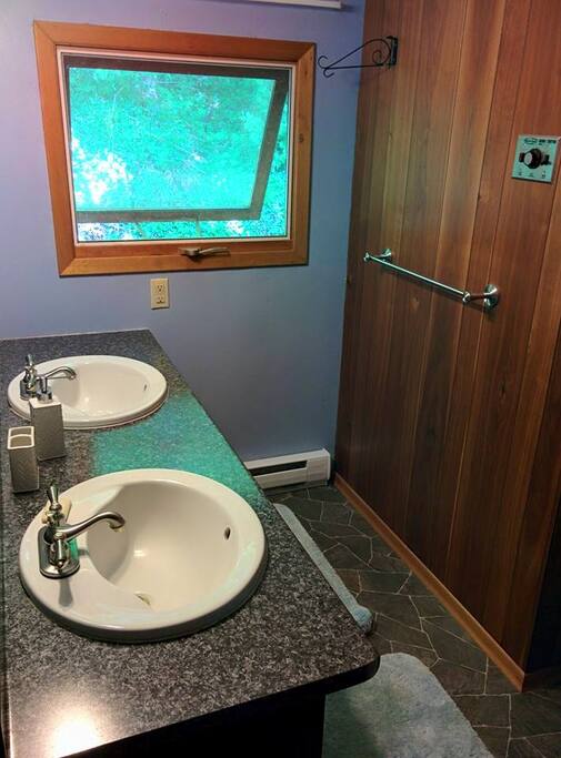 Upper bathroom with full shower, sauna and double sink.