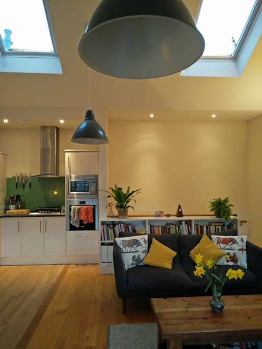 Bright living space from large windows and overhead automated skylights