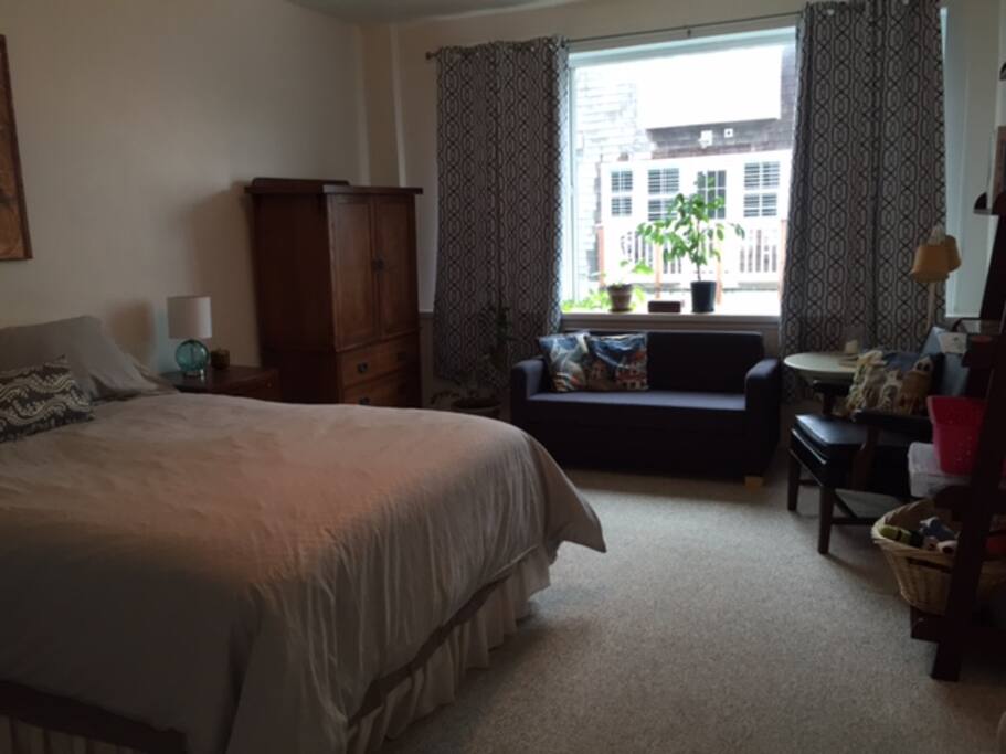 large bright bedroom with sitting area