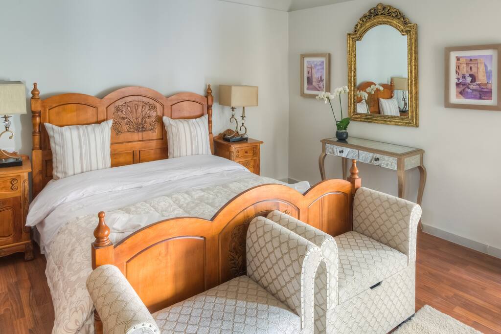 Luxurious king size bed with en-suite bathroom and balcony