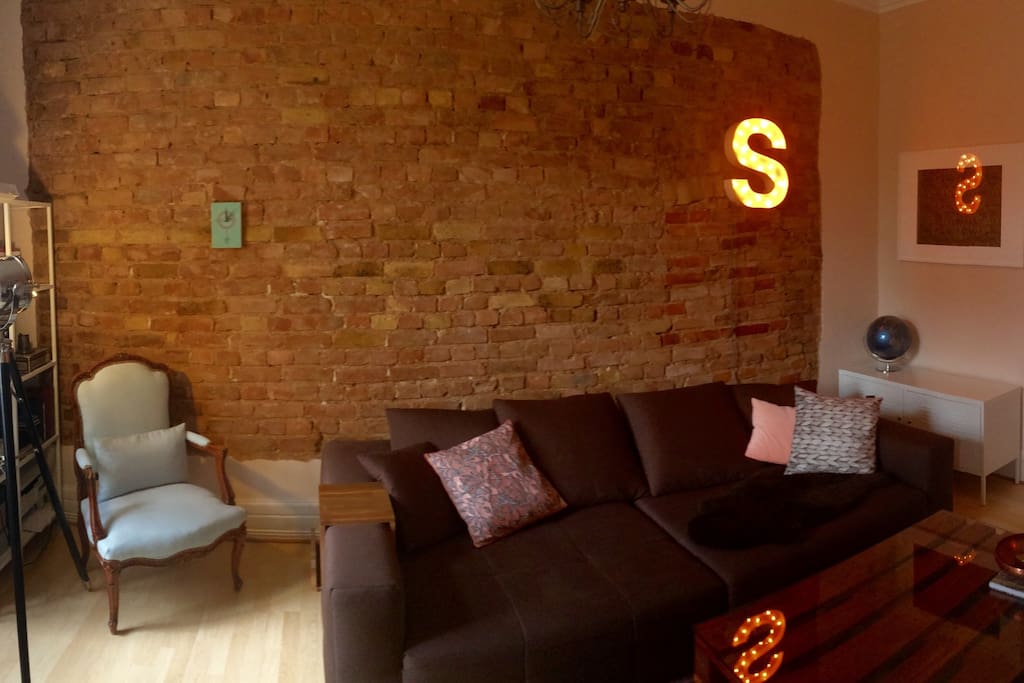 I just loooove the brick wall of the living room, and you will too. The house is 150 years old, so yes, it's a real brick wall :). Some of the furniture you see, I built or restored myself.