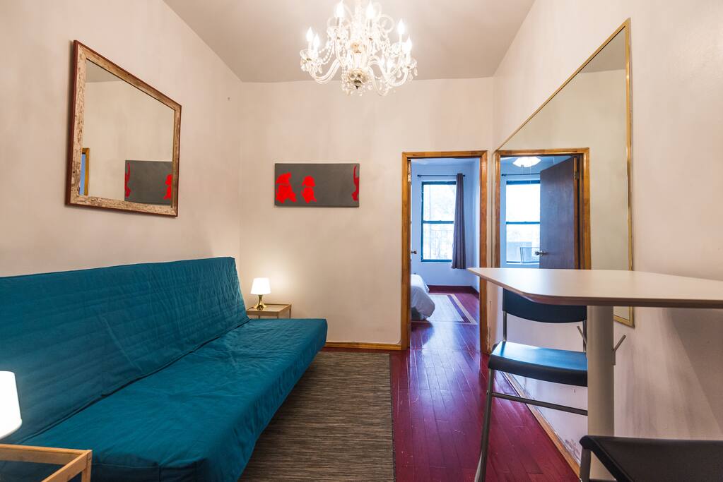 Living room area with pullout full size sleeper and table area