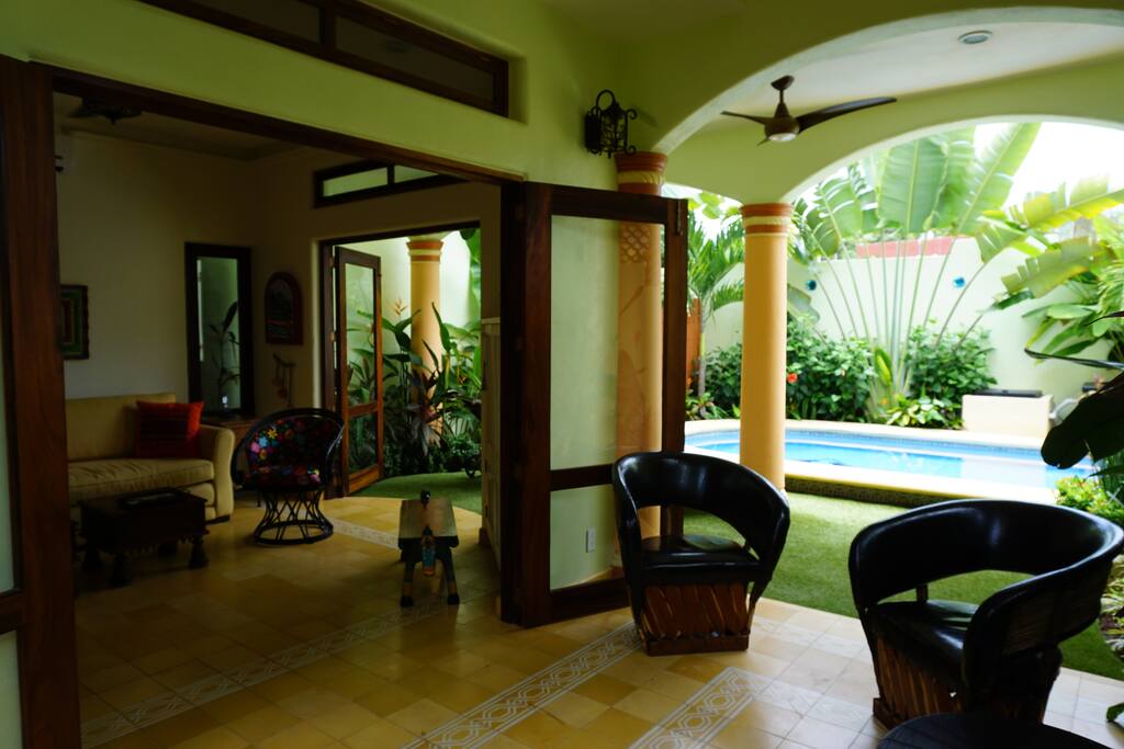 Looking from outdoor living room to living room and pool