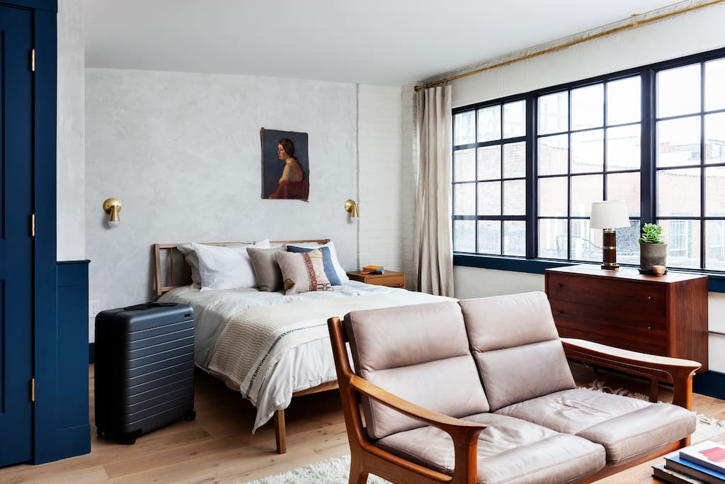 Queen Bed open to living area with Casper Mattress & Parachute Linens.