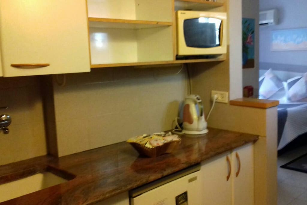 kitchenette with mini fridge 2 electric burners microwave kettle tea coffee...