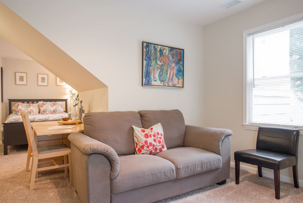 Relax all cool in this super comfy couch 'neath jazzy art.