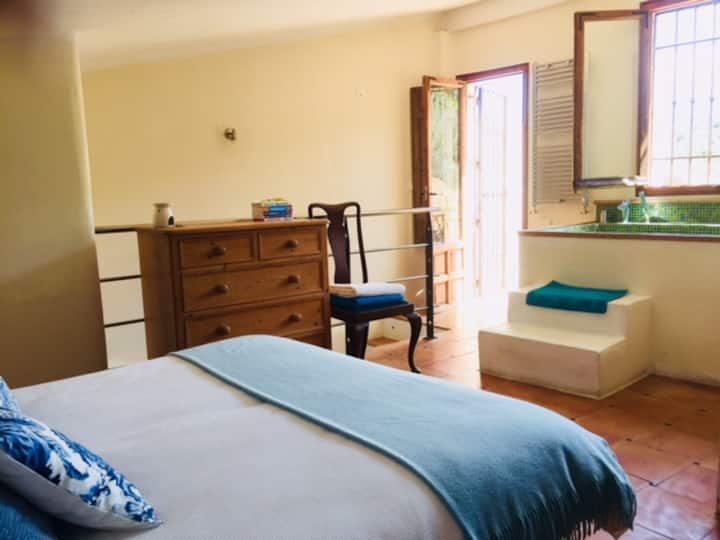 Top floor double bedroom opens on to its own terrace and outside bath where you can bathe under the stars.